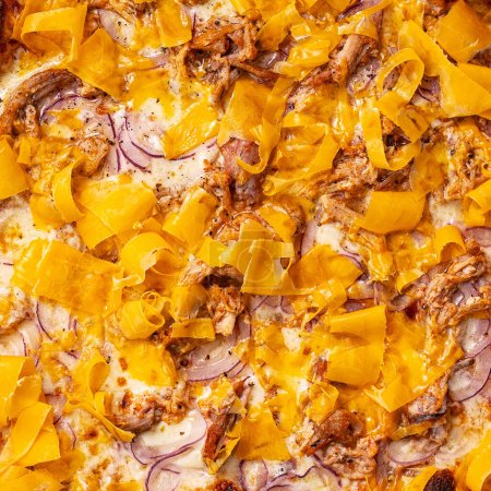 Foto de Primer plano de relleno y textura de pizza, cebollas rojas, carne, queso cheddar en la parte superior - Imagen libre de derechos
