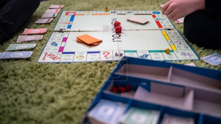 Photo for BOLOGNA, ITALY - MARCH 2020: Monopoly Board Game. The classic real estate trading game, Monopoly has become a part of international popular culture, having been licensed in more than 103 countries. - Royalty Free Image