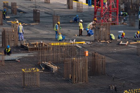 Photo for DUBAI - OCTOBER, 2018: Men at work on new constuction site besides the Water Canal. - Royalty Free Image