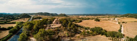 Photo for Panoramic aerial view of Eremita de Fatima Church in Mahon, against a white cloudy sky. Menorca, one of the Balearic Islands located in the Mediterranean Sea belonging to Spain. - Royalty Free Image