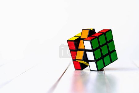 Photo for BOLOGNA, ITALY - APRIL 2019: Rubik's Cube on a table isolated against white background. Illustrative editorial. Concept of problem solving, solution, focus and goal. - Royalty Free Image