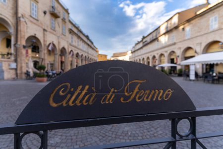 Photo for Fermo City metal plate with Piazza del Popolo (People square), the main monumental square of the city, in the background. Fermo, Marche Region, Italy. - Royalty Free Image