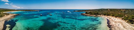 Photo for Sea coastline panoramic aerial view with boats in Menorca, one of the Balearic Islands located in the Mediterranean Sea. - Royalty Free Image