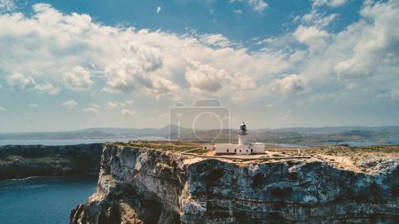 Photo for Panoramic aerial view of rocky coastline with Cape Cavalleria Lighthouse. Menorca, one of the Balearic Islands located in the Mediterranean Sea belonging to Spain. - Royalty Free Image