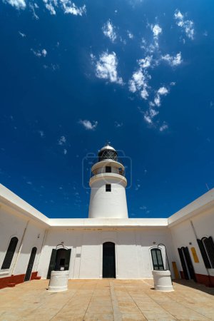 Photo for Cape Cavalleria Lighthouse against blue sky. Menorca, one of the Balearic Islands located in the Mediterranean Sea belonging to Spain. - Royalty Free Image