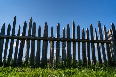 Photo for Wooden fence against blue sky. - Royalty Free Image