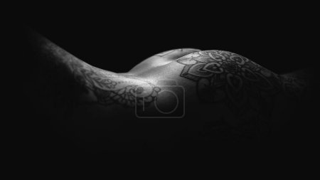 Photo for Sensual naked woman studio portrait covered with tattoo against black background. Black and withe artistic photo. - Royalty Free Image