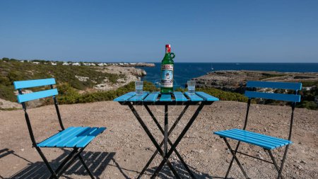 Photo for MINORCA, SPAIN - JULY 2019: Gin Xoriguer bottle of Gin in Binidali creek in Minorca, Balearic Islands, Spain. - Royalty Free Image