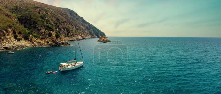 Photo for Group of friends having fun on sailing boat. Aerial view, filtered image. Giglio Island, Tuscany, Italy. - Royalty Free Image