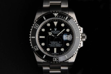 Photo for BOLOGNA, ITALY - MARCH, 2020: Rolex Submariner watch close up against black background. Rolex SA is a Swiss luxury watchmaker, founded in London, England in 1905. Illustrative editorial. - Royalty Free Image