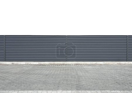 Urban steel corrugated fence placed on a white background along the road. Gray modern fence or hedge. Urban environment. Template or mockup