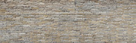 Foto de Una antigua cerca o pared de un edificio construido con piedra cáscara o bloques de piedra arenisca. Textura o patrón - Imagen libre de derechos