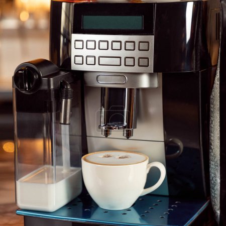 Coffee machine with white cup close up