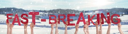Téléchargez les photos : People Hands Holding Red English Word Fast-Breaking. Snowy Winter Background With Snowflakes - en image libre de droit