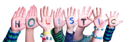 Foto de Children Hands Building Colorful English Word Holistic (en inglés). Fondo blanco aislado. - Imagen libre de derechos