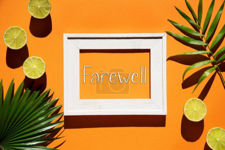 Flat Lay With English Text Farewell. Fondo naranja con marco de imagen y limón tropical y hoja de palma.