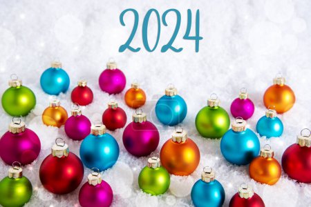 Foto de Texto 2024, En nieve blanca, Con muchas bolas de Navidad de colores, Fondo de invierno - Imagen libre de derechos