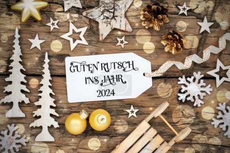 Foto de Fondo de Navidad rústico de madera Bokeh, decoración de invierno con etiqueta con texto alemán Guten Rutsch Ins Jahr 2024, que significa feliz año nuevo 2024 en inglés - Imagen libre de derechos