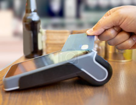 Side view of credit card contactless payment at shop