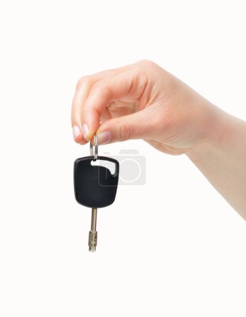 Photo for Woman hand giving a car key isolated on a white background - Royalty Free Image