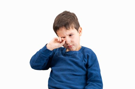Close up of child scratching itchy eye with white background.