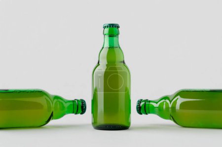 Green steinie beer bottle mockup on a grey background.