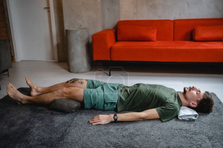 Téléchargez les photos : One modern caucasian man adult male practice restorative yoga at home - en image libre de droit