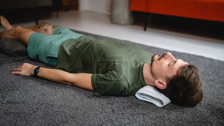 Téléchargez les photos : One modern caucasian man adult male practice restorative yoga at home - en image libre de droit