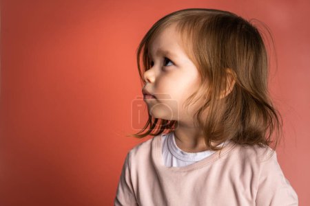 Photo for One small caucasian girl 2 years toddler in front of pink background studio shot waist up copy space - Royalty Free Image
