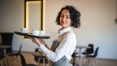 Photo for One mature woman caucasian waitress at cafe or restaurant carry tray with coffee female entrepreneur at work real people copy space small business concept - Royalty Free Image