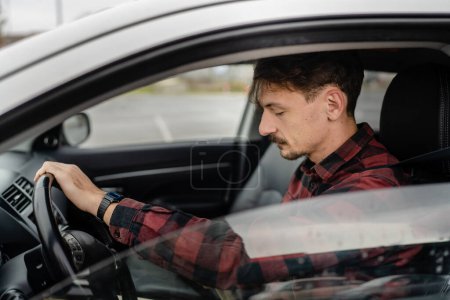 Photo for One man caucasian male with brown hair and mustaches sitting in a car adult driver wear shirt while driving automobile travel transport concept real people copy space side view - Royalty Free Image