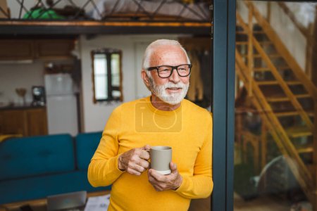 Photo for One man senior caucasian male with beard and eyeglasses stand on balcony at door in day happy smile hold cup of coffee copy space morning daily routine concept - Royalty Free Image
