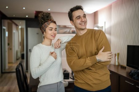 Photo for Happy couple woman and man caucasian husband and wife or girlfriend and boyfriend standing at home happy smile in their apartment real people copy space - Royalty Free Image
