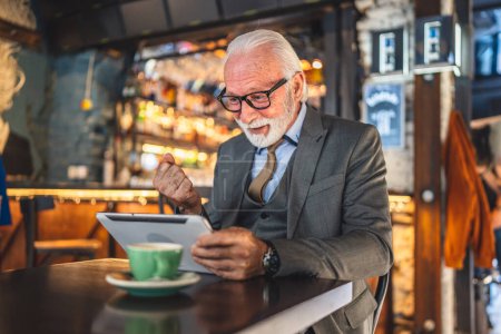 Photo for One Senior man caucasian male businessman business owner use digital tablet sit at cafe have video call talk connection and communication wear suit copy space - Royalty Free Image