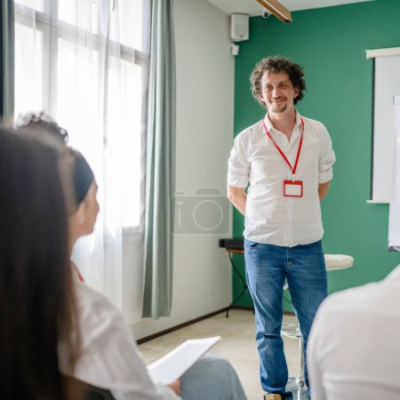 Photo for Coach training speak explain question to group of employees at seminar - Royalty Free Image