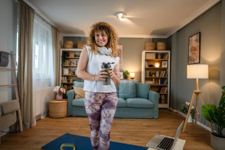 Photo for Portrait of caucasian adult woman with curly hair stand at home hold supplement shaker wear white t-shirt before or after training healthy lifestyle concept copy space - Royalty Free Image