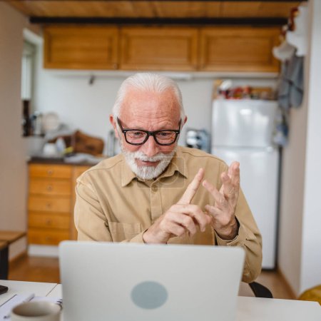 Photo for Senior caucasian man use laptop computer to make a video call at home - Royalty Free Image