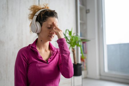 Photo for One woman adult caucasian female millennial using headphones for online guided meditation practicing mindfulness yoga with eyes closed on the floor at home real people copy space self-care concept - Royalty Free Image