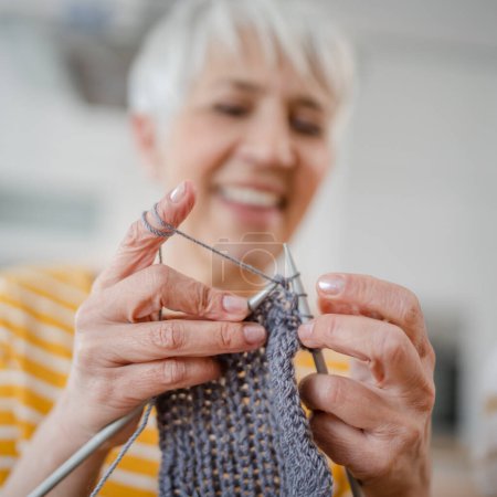 Photo for Close up on hands of senior caucasian woman needle work knitting - Royalty Free Image