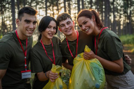 Photo for Portrait of group of friends volunteers prepare to collect garbage waste and clean forest nature in summer day slow motion - Royalty Free Image