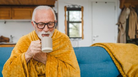 Photo for One caucasian male senior man sit on sofa bed at home hold cup of tea common cold sneezing sick caught cold - Royalty Free Image