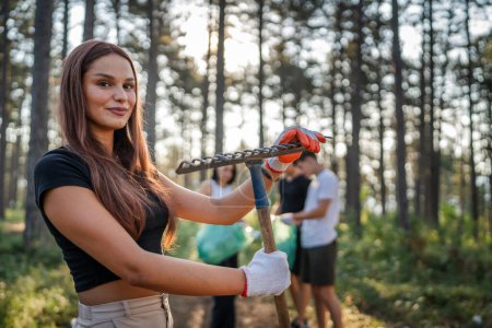 Téléchargez les photos : Portrait de militante adolescente caucasienne bénévole pendant la cueillette de déchets bouteilles en plastique papier provenant de la forêt nettoyage de la nature dans la journée ensoleillée écologie concept de la campagne de protection de l'environnement - en image libre de droit