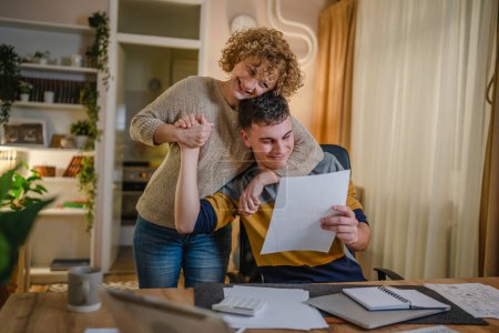 Photo for Mature woman and son caucasian man teenager receive letter read good news student get scholarship or invitational letter from university share good news and excitement with his mother real people - Royalty Free Image