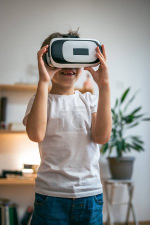 Photo for Boy male caucasian child at home enjoy virtual reality VR headset - Royalty Free Image