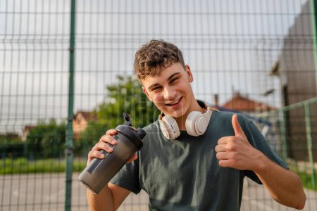 Photo for One young caucasian man teenager hold supplement shaker stand outdoor - Royalty Free Image
