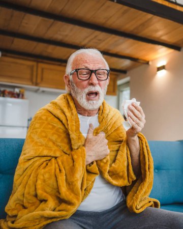 Photo for One caucasian male senior man sit on sofa bed at home hold Paper tissue common cold sneezing - Royalty Free Image