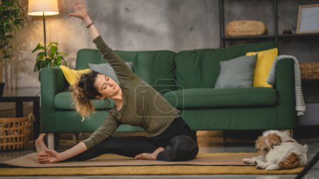 Photo for Woman practice yoga on mat in living room at home - Royalty Free Image