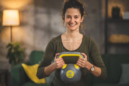 Photo for One adult woman training at home use kettlebell girya weight - Royalty Free Image
