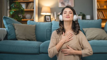 Photo for One woman adult caucasian female millennial using headphones for online guided meditation practicing mindfulness yoga at home real people self care concept copy space - Royalty Free Image