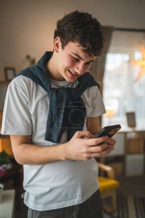 Photo for One man caucasian male teenager boy use mobile phone smartphone sms - Royalty Free Image